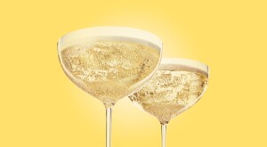 two glasses of champagne with a yellow background