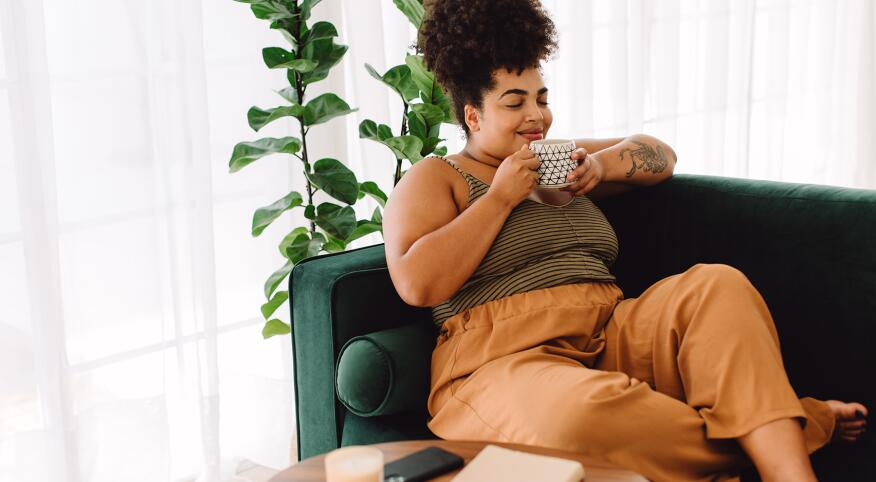 image_of_woman_sitting_down_with_beverage_mug_GettyImages-1345219485_1800