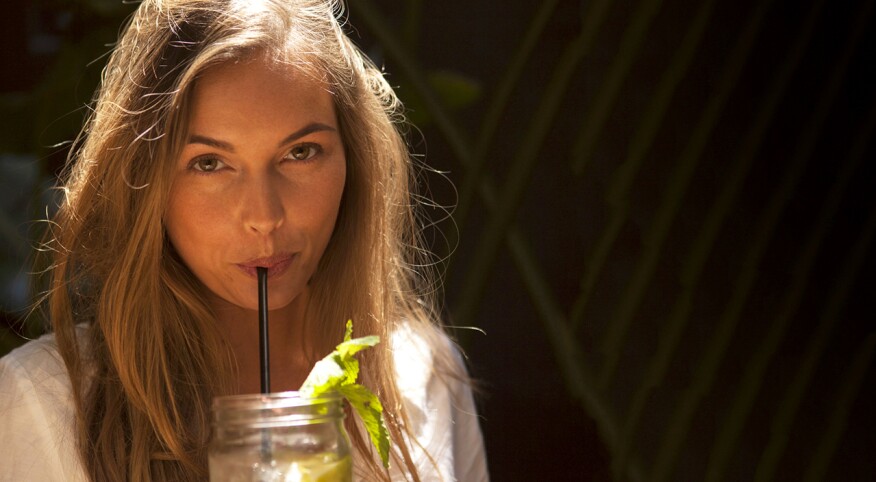 Woman drinking out of a mason jar