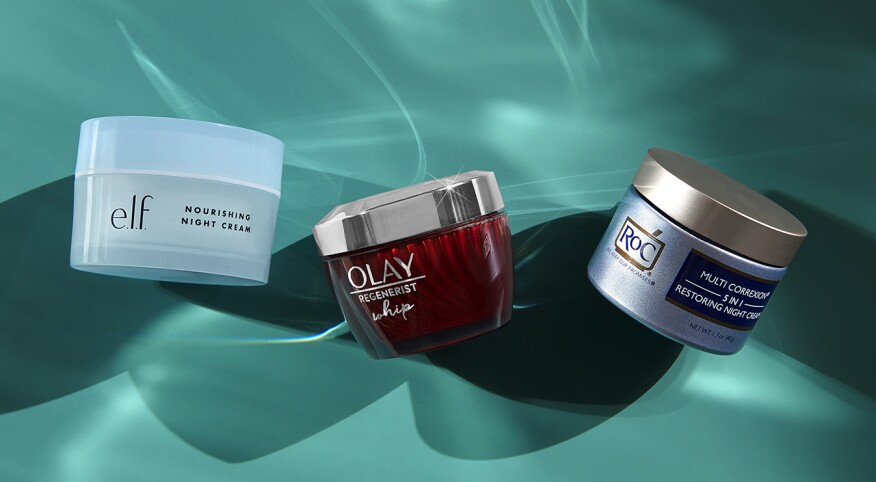 three drugstore night creams on a blue-green background