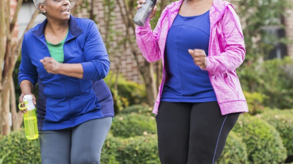 Two senior black women pwer walking