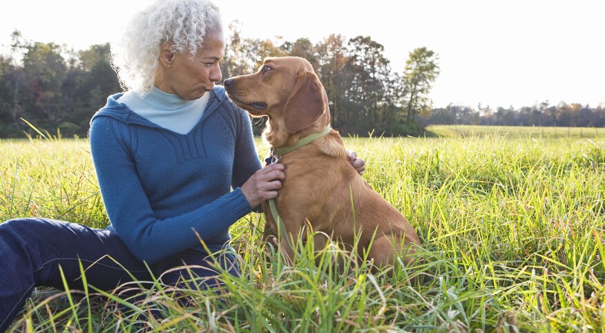 image_of_woman_and_dog_outside_in_field_GettyImages-99277791_1800