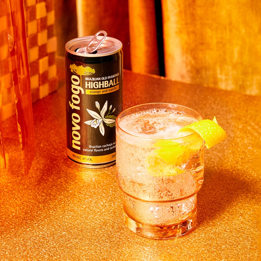 Product shot of low calorie alcohol in front of gold curtain