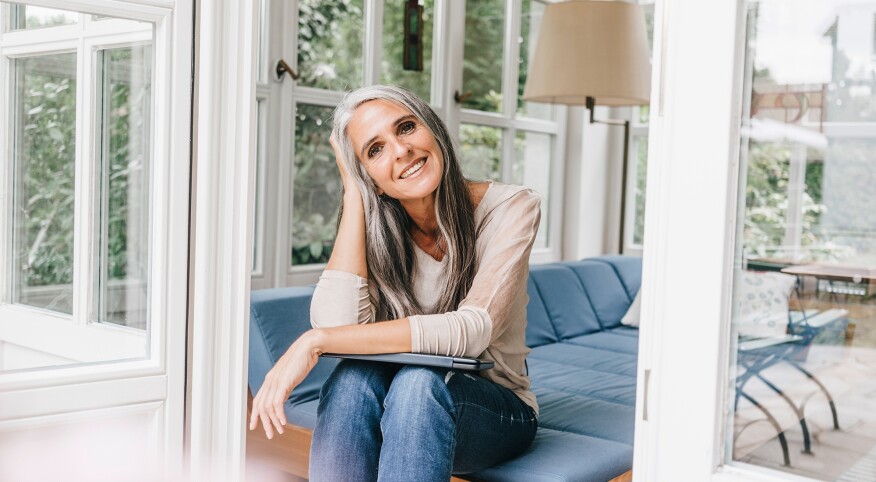 Woman with gray hair sitting on porch