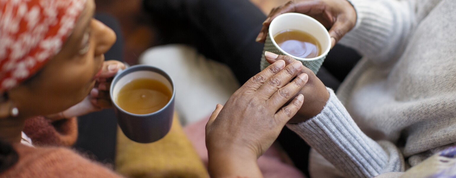 Women friends talking, drinking tea