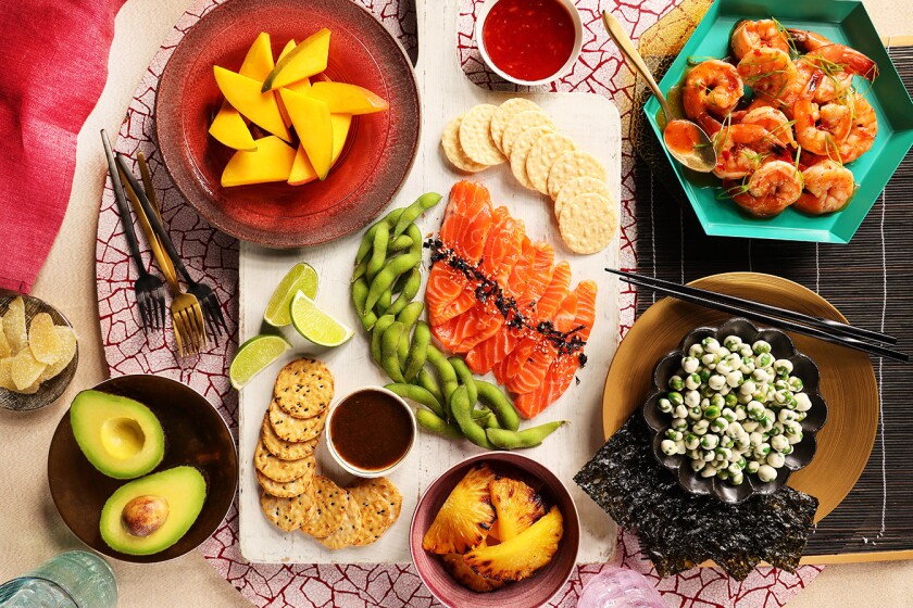 Overhead shot of charcuterie board styled with bright tablewear