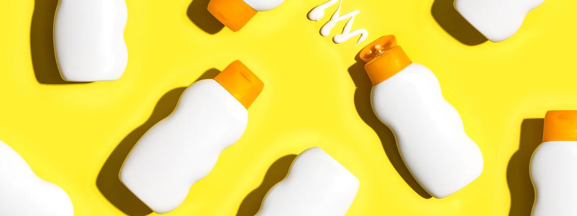 Sunscreen products on yellow background