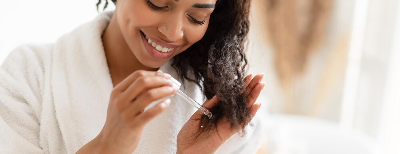 image_of_woman_applying_oil_to_ends_of_hair_GettyImages-1322880152_1800