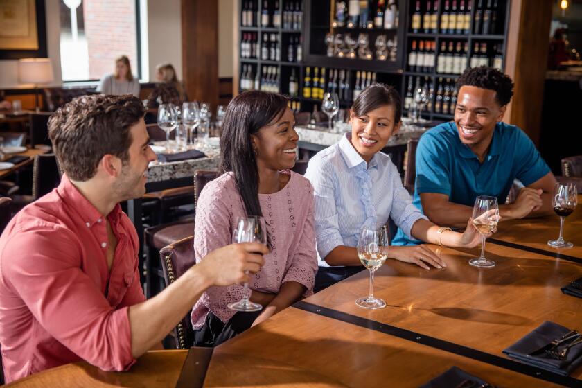 Group of friends drinking wine at a bar