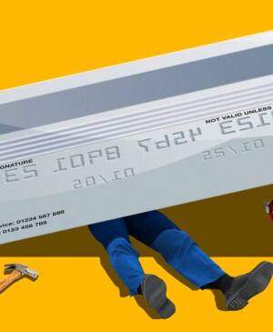 Photo composite of a man under a credit card with tools looking like a mechanic trying to fix it.