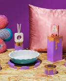9 gifts spread across a chipboard surface with a purple background 