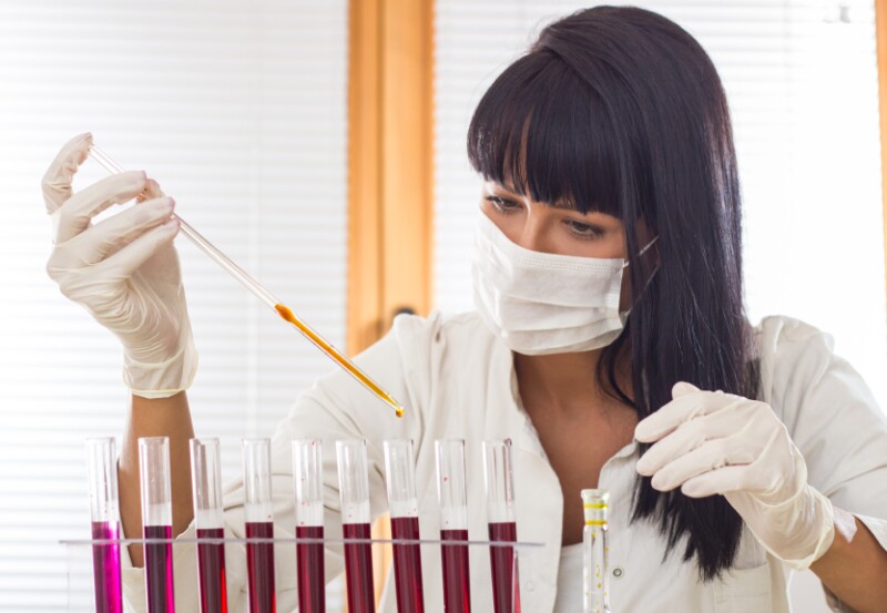 Scientist in white uniform working in laboratory