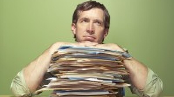 Man with piles of work