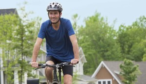 Man riding bicycle in his community