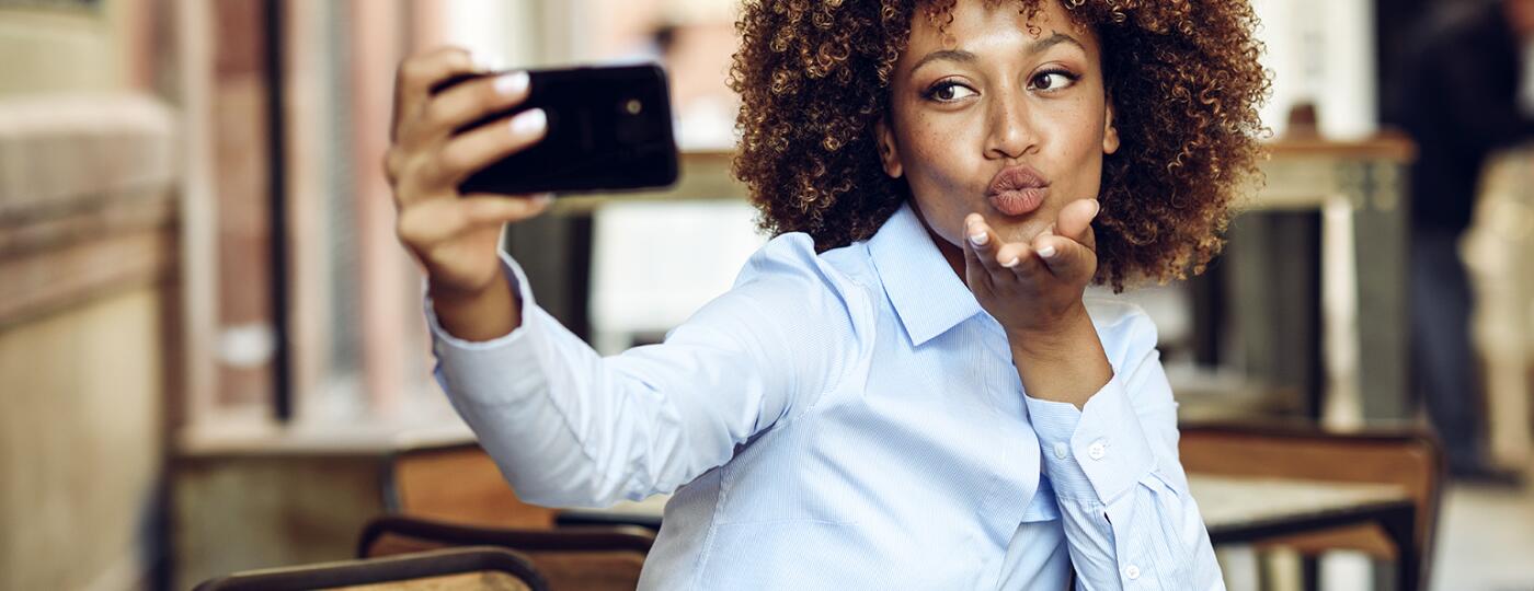 image_of_african_american_woman_taking_selfie_with_phone_GettyImages-946920772_1540