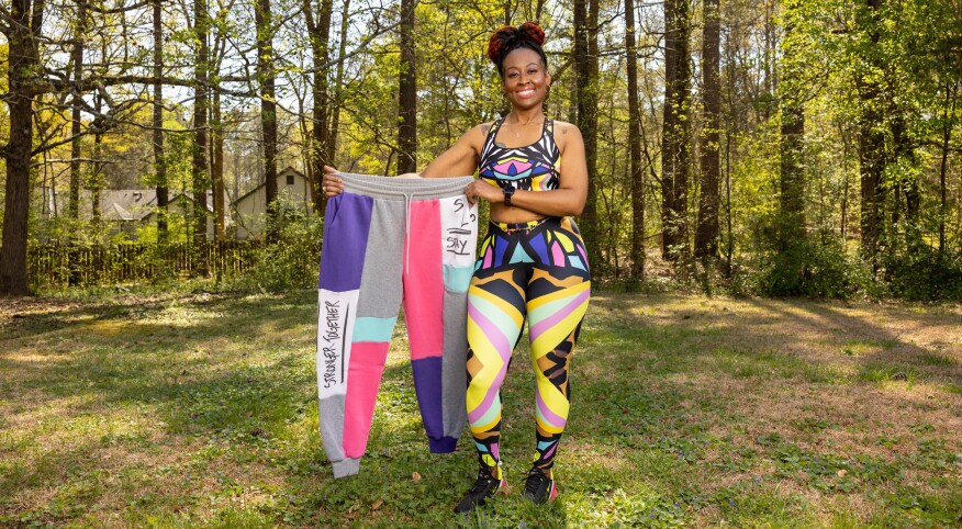 Melissa Copeland holding a pair of her old pants before weightloss
