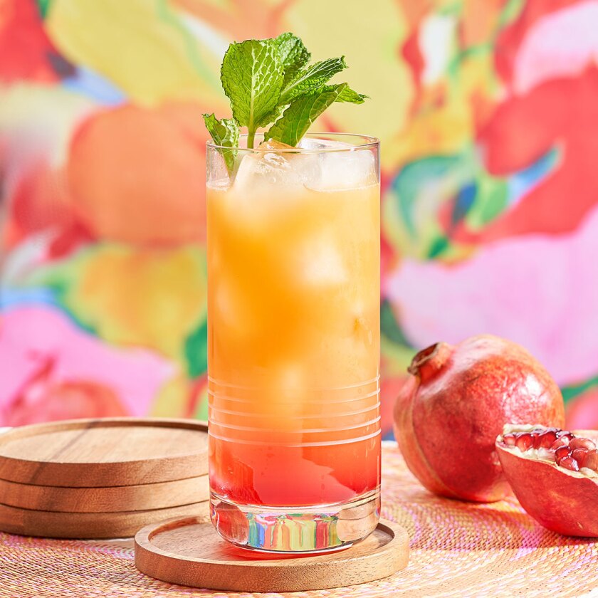 Summer sunset cocktail styled with colorful props