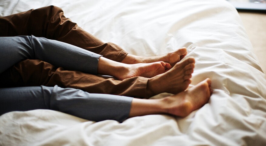 Married couple alone in bed while kids are at summer camp.