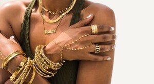 image of black woman wearing layers of gold jewelry