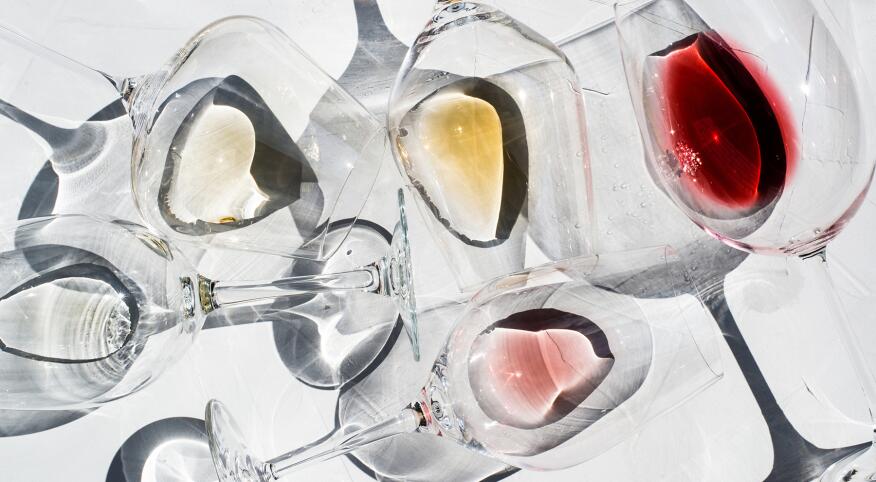 Wine Glasses on a white surface with With Different Types Of Wine inside