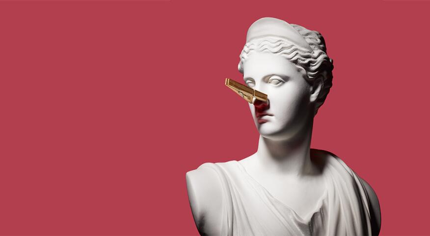 A white bust statue wears a clothespin on its nose to combat the smell of perimenopause symptoms.
