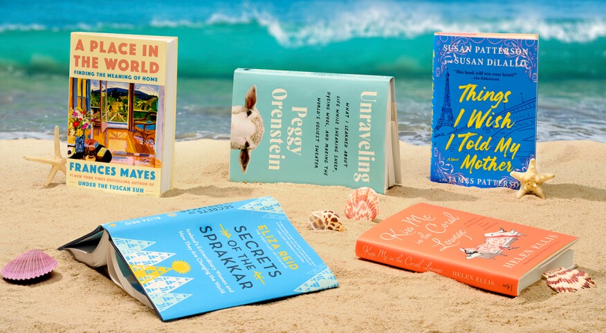 Books styled in the sand