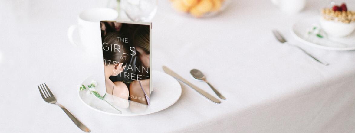 An image of Yara Zgheib's new novel, The Girls at 17 Swann Street, staged on a dining table.
