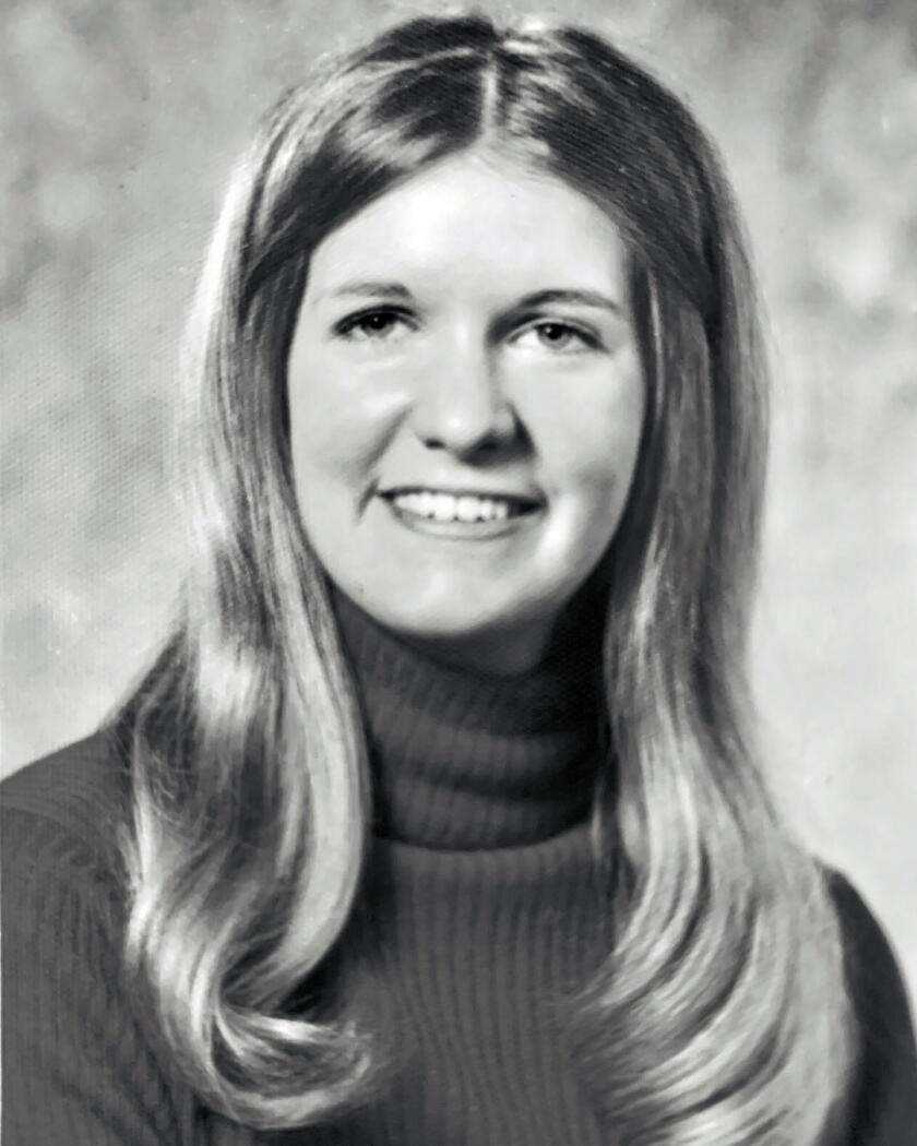 Portrait of author Janis E. Mills in high school.