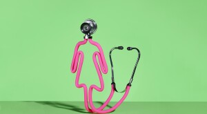 a pink stethoscope in the shape of a female on a green background