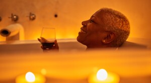 image_of_woman_bathing_with_wine_and_candles_GettyImages-1192135322_1800