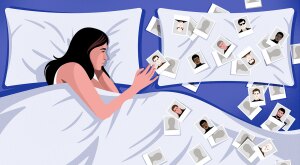 Woman lying in bed looking at photos of men