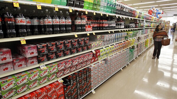 A shopper walks by the sodas aisle at a grocery store in Los Angeles