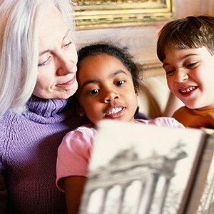 Grandmother reading to grandchildren