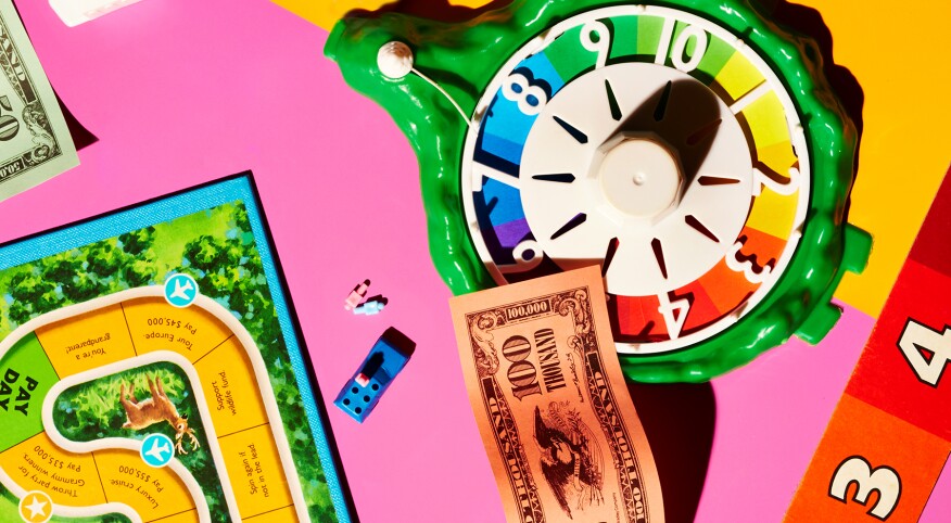 a game night involving paper money, and a number spinner, bright rainbow colors