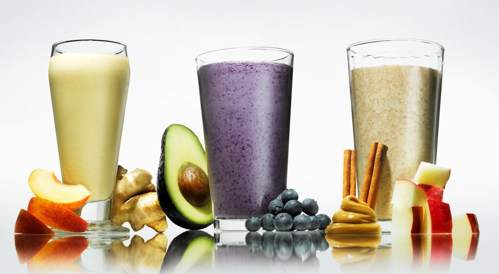 three smoothies with some ingredients around them