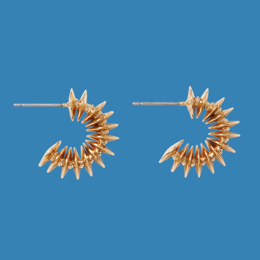 Golden disc huggie earrings on white background
