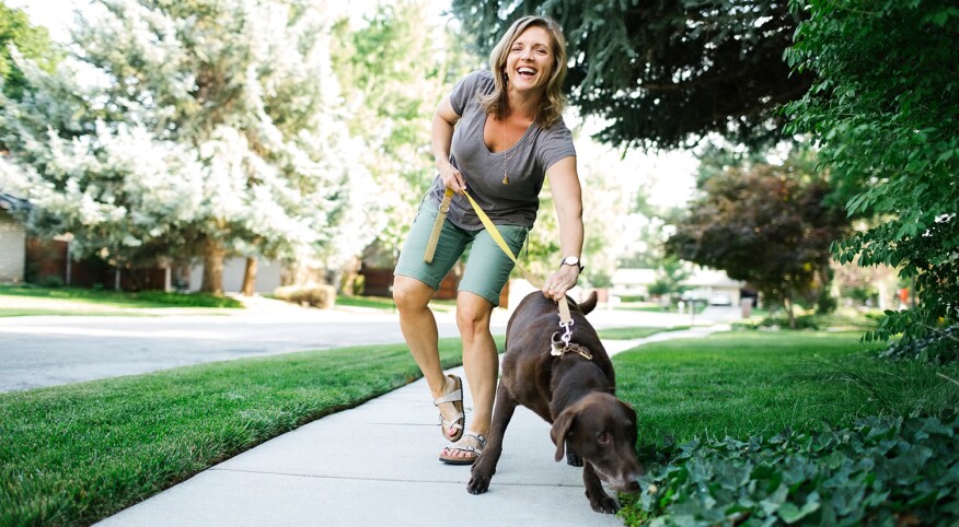 Woman walking with Labrador Retriever