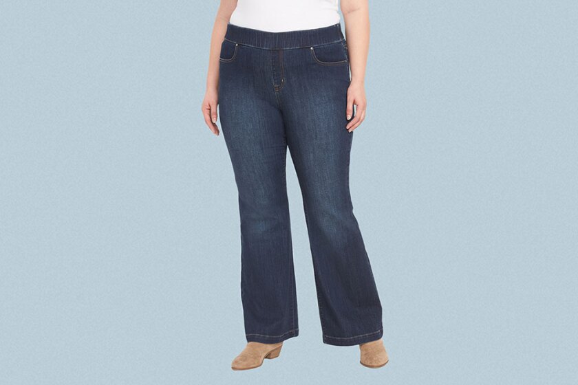 Woman wearing flare jeans on grey background