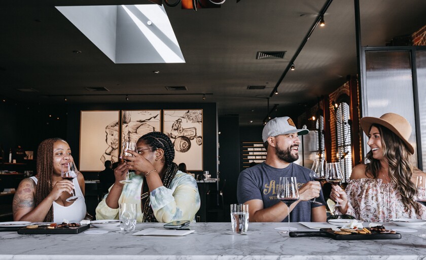 Four people enjoying wine at Brown Estate Vineyard