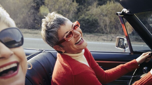 Happy mature women driving in convertible car