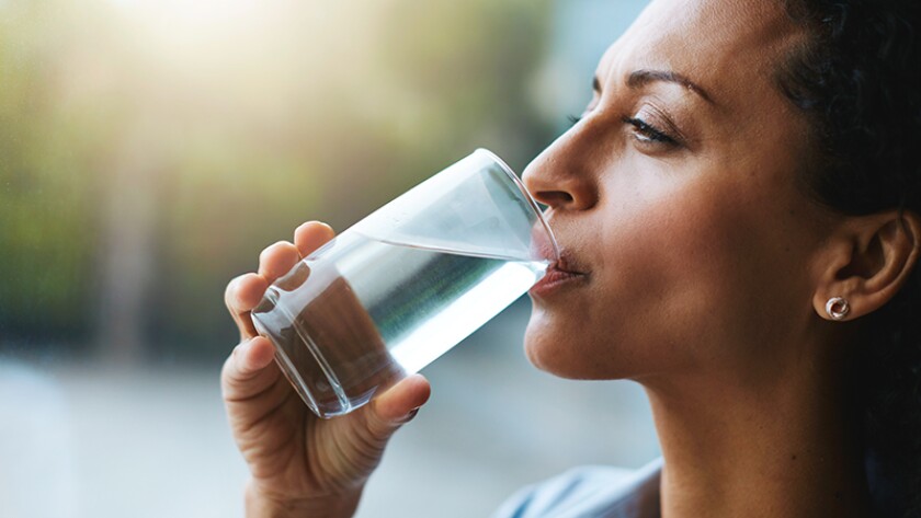 woman drinking water from a glass