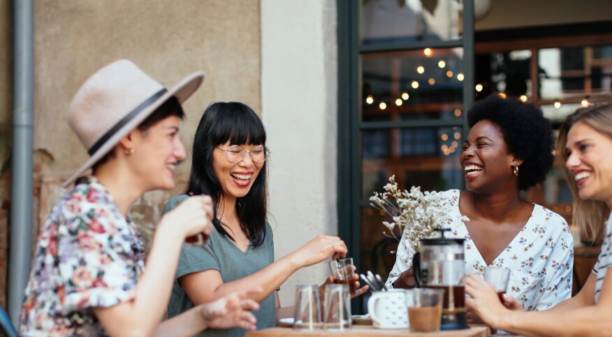 Group of women having coffee together at an outdoor restuarant