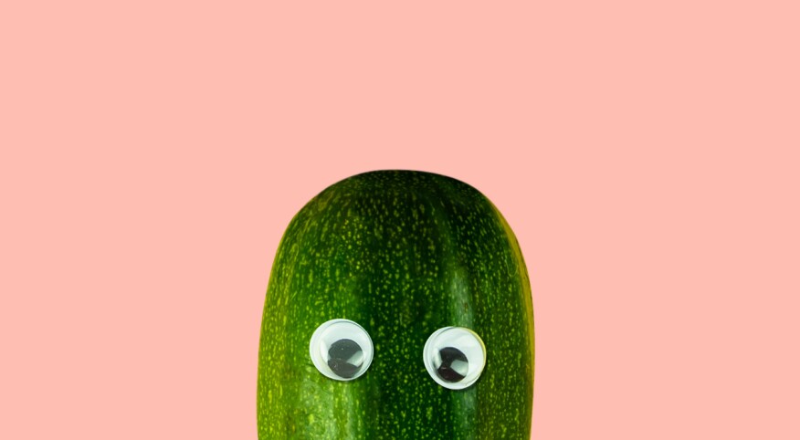 Top of a green squash with toy eyeballs on it