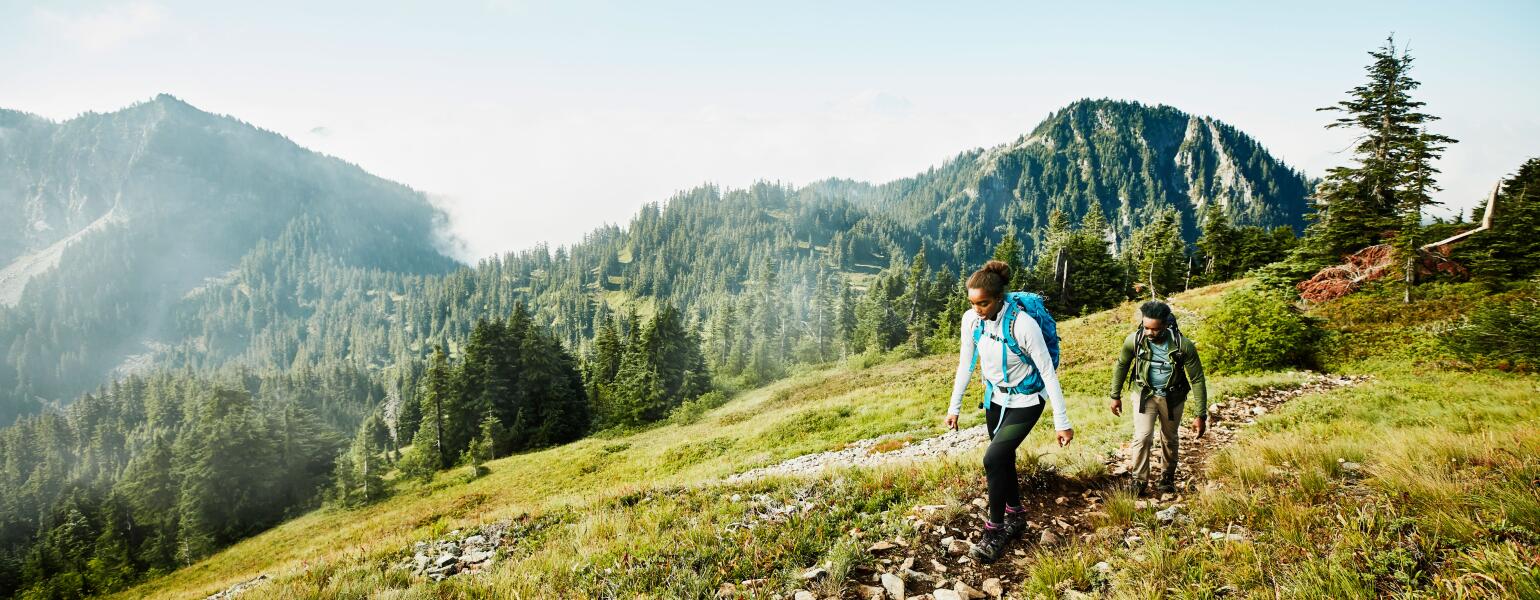 Female and male hiking in the mountains