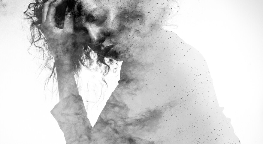 Unhappy woman's form double exposed with paint splatter effect