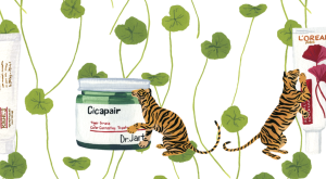 Illustration of tigers next to skin care products with tiger grass in the background 
