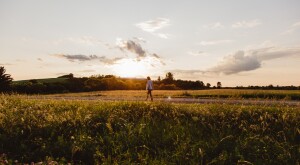 woman walking on a countryside road at dusk, finding the beauty in 2020