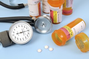 Pill bottles next to stethoscope