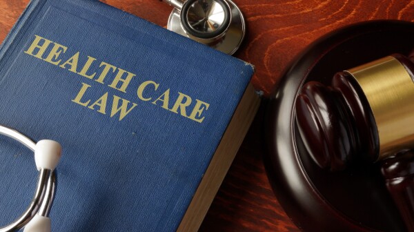 Book with title Health Care Law on a table.