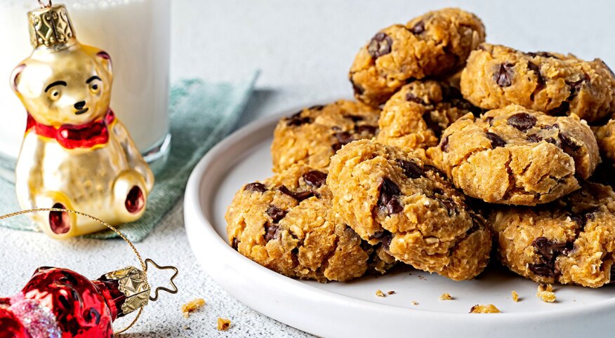 Cookies on a plate styled next to holiday ornaments